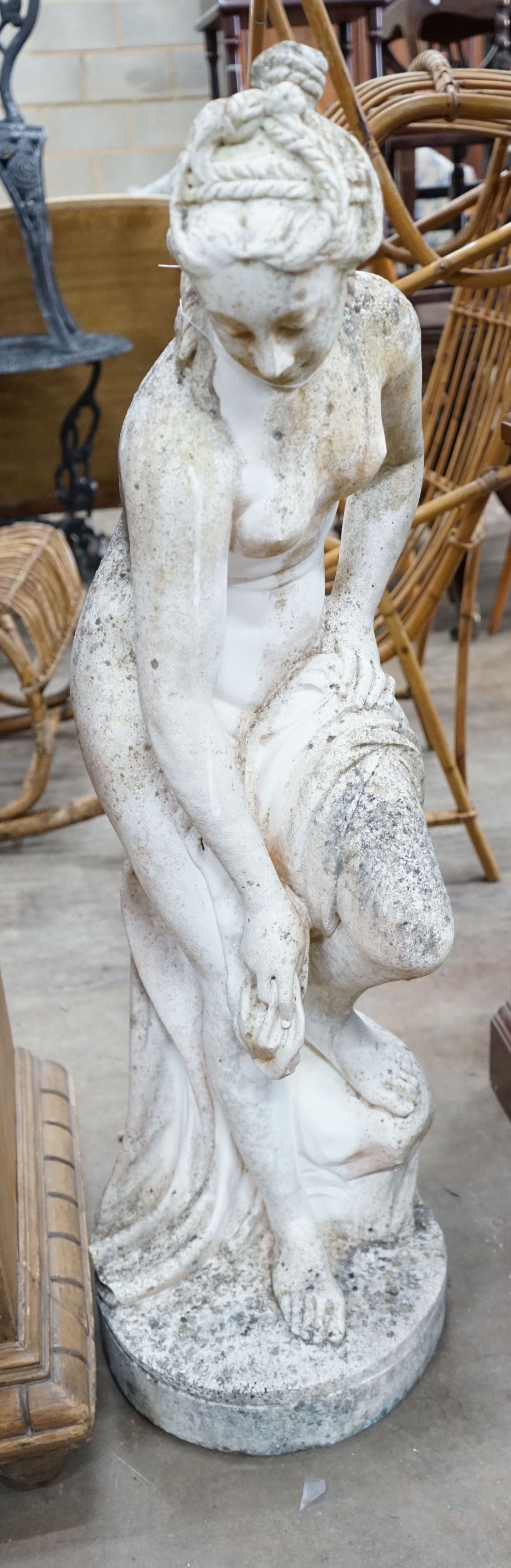 A reconstituted stone garden ornament of a female bather, height 102cm